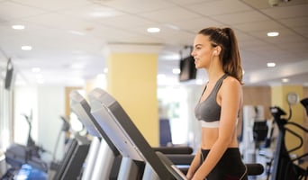 Modern commercial fitness facility with natural light, ergonomic equipment, and active recovery zone designed by Athletic Vision