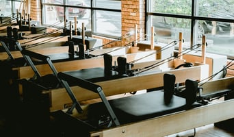 Fully standardized premium Pilates studio floor featuring uniform apparatus for optimal member retention and operational consistency by Athletic Vision
