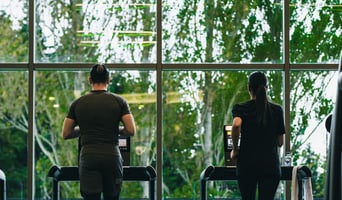 Autonomous hotel gym facility featuring intuitive commercial cardio lines and a dedicated post-travel recovery zone designed by Athletic Vision